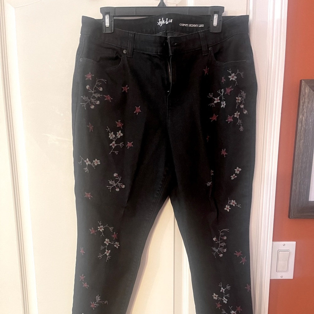 Black pants with flower prints all over